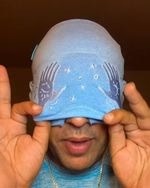 Person wearing the ocean blue migraine relief cap